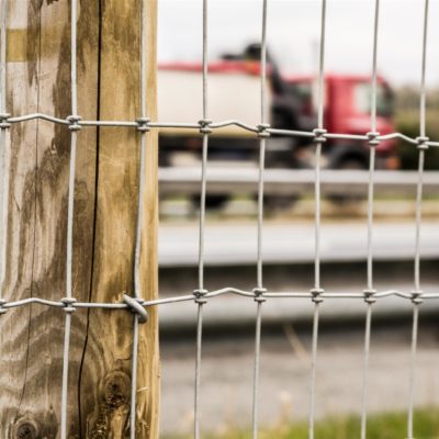 road fencing in front of red lorry
